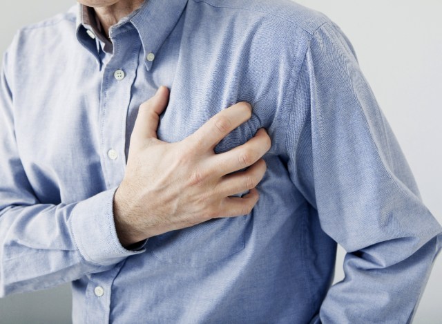 an older man feels chest pain, heart attack