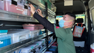 a person in a green shirt with supplies