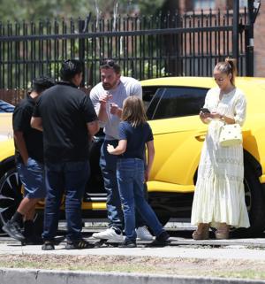 Ben Affleck and son Samuel talk while Jennifer Lopez sends messages nearby.